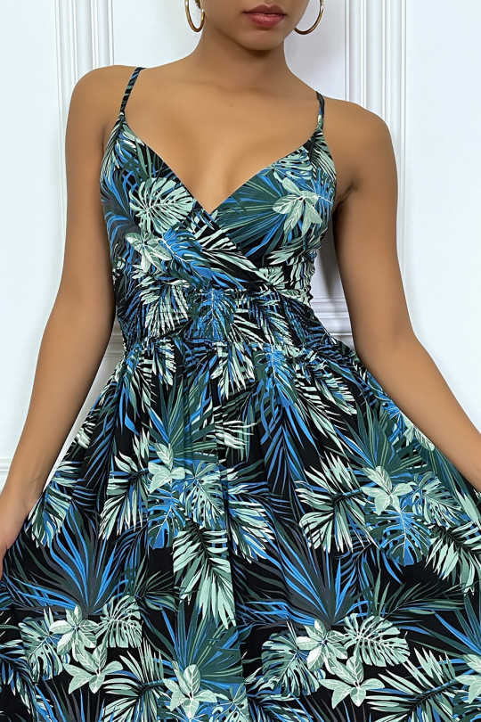 Long royal blue summer dress with tropical print and cinched at the waist.