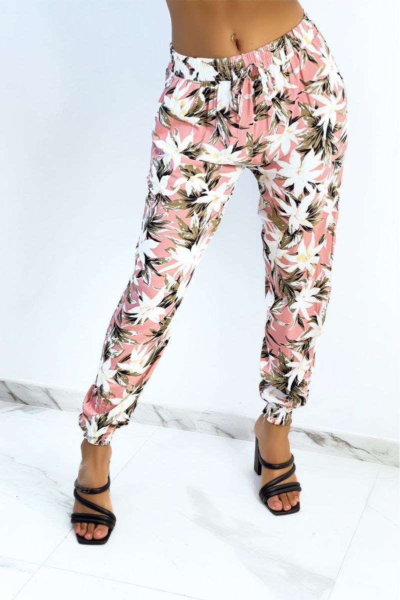 Flowing pink pants with tropical print tightened at the ankles - 1