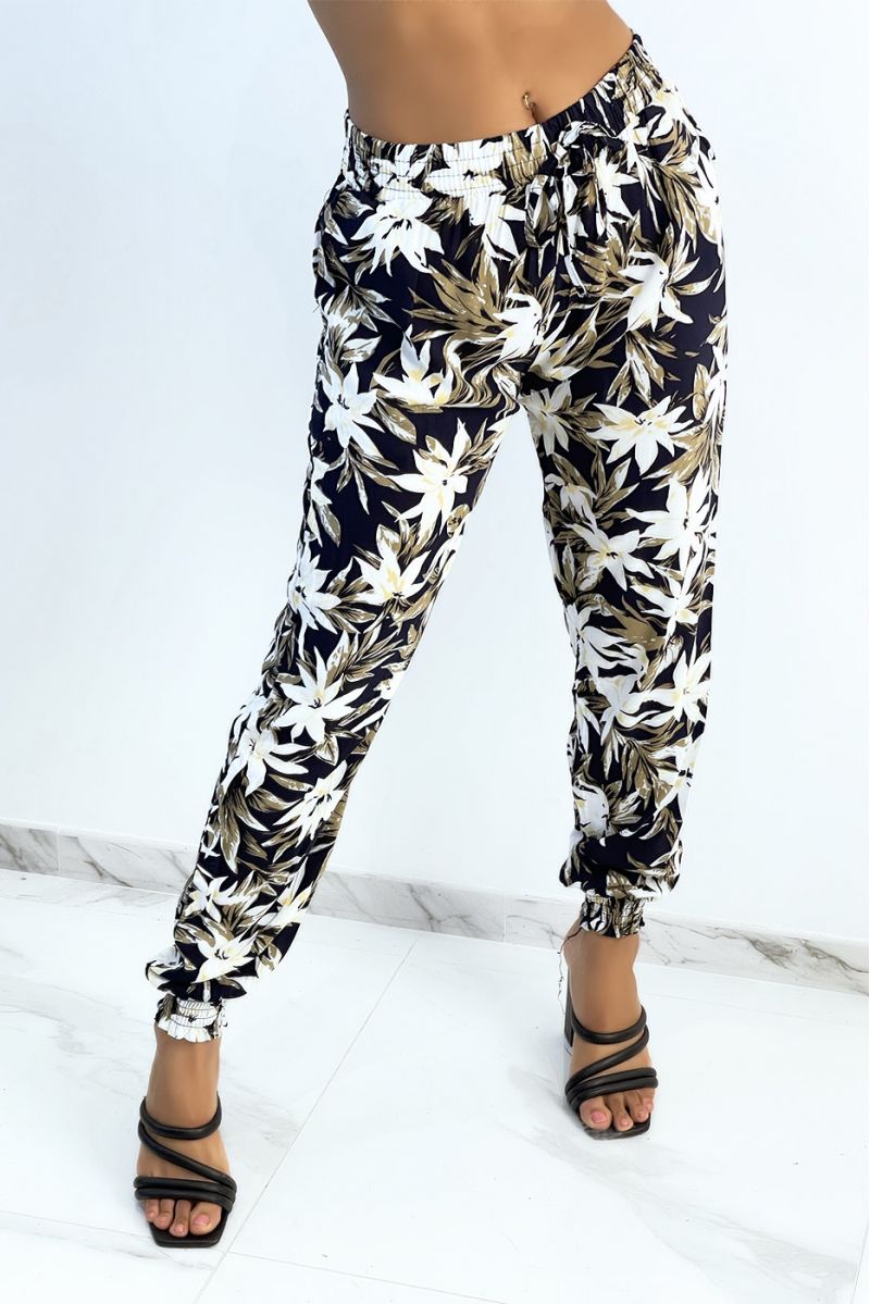 Fluid navy pants with tropical print tightened at the ankles - 1