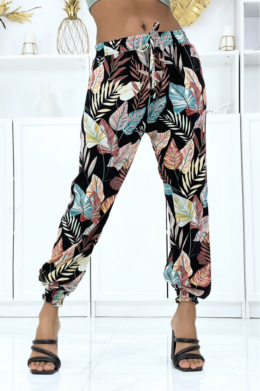 Fluid black foliage trousers with elastic waist and ankles
