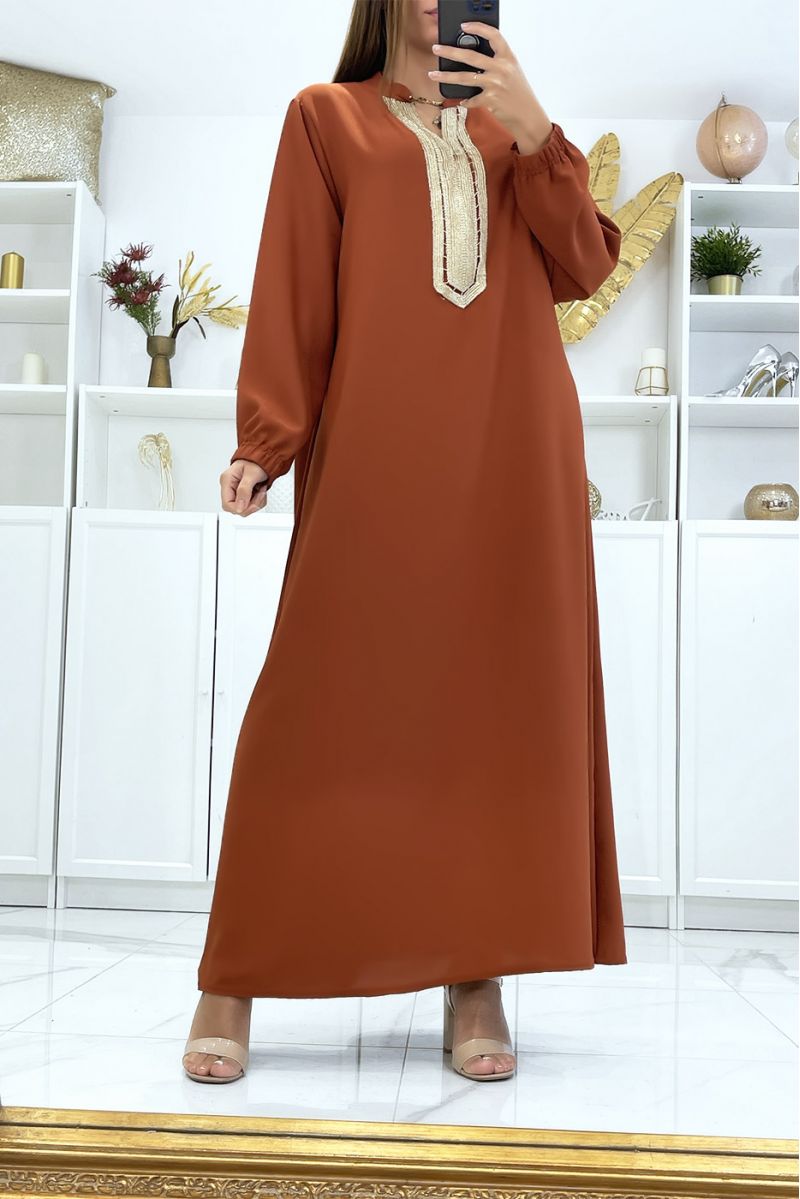 Black abaya with beige piping and gold cord at the collar