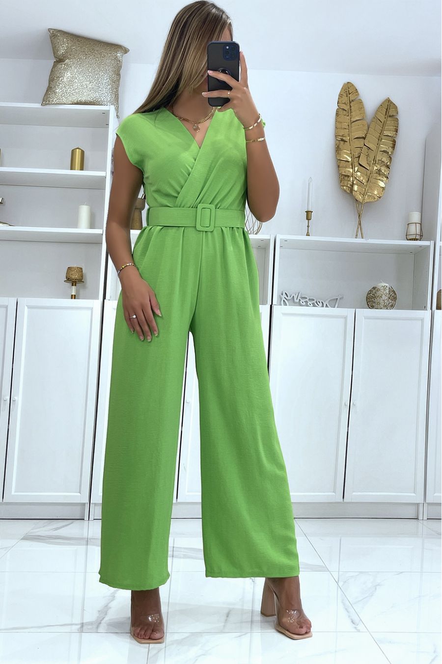 Neon green belted jumpsuit with flared pants and wrap effect top