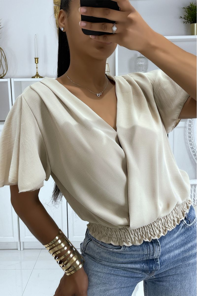 Flowing beige wrap top, fitted at the lower abdomen - 1