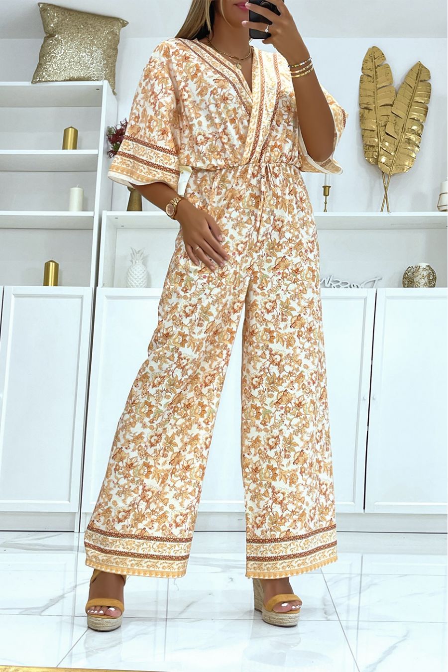Beige met witte bell bottom jumpsuit getailleerd in de taille met mooie bloemenprint - 1