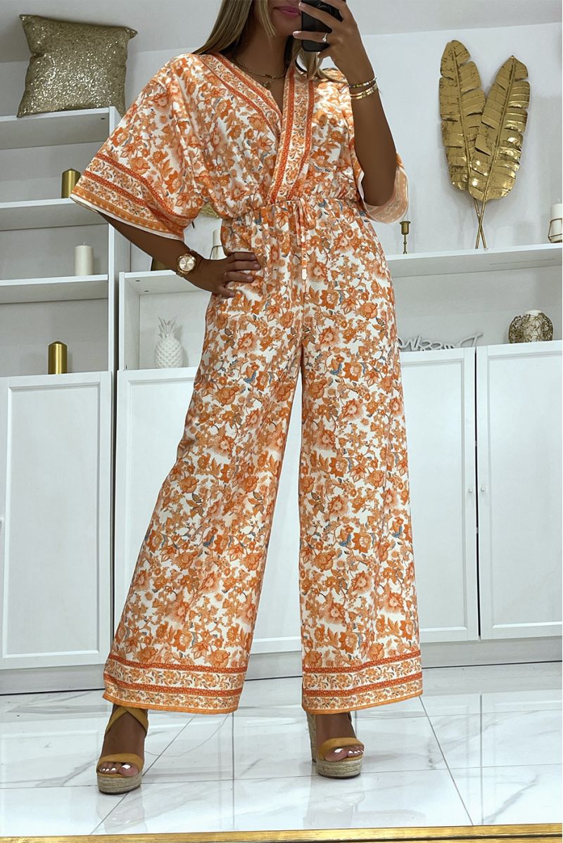 Oranje bell bottom jumpsuit getailleerd in de taille met mooie bloemenprint - 1