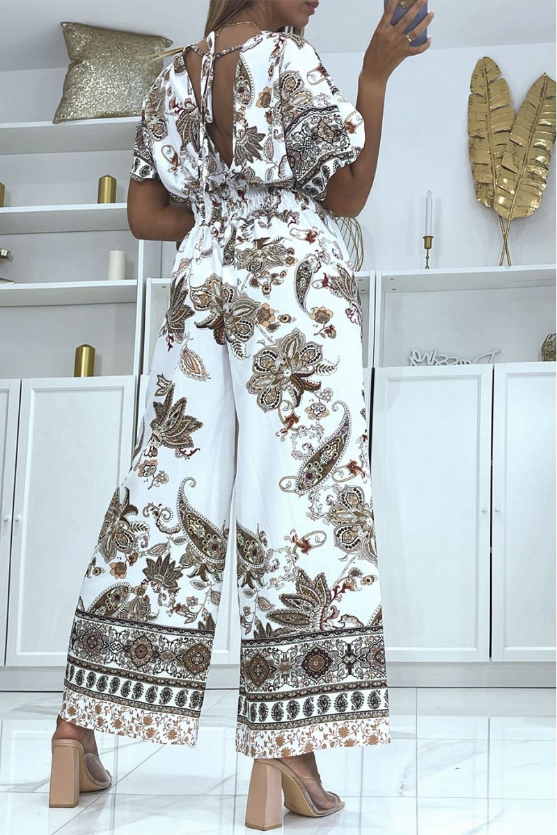 Witte jumpsuit met overslag en bell bottoms elastische tailleband met taupe print - 1