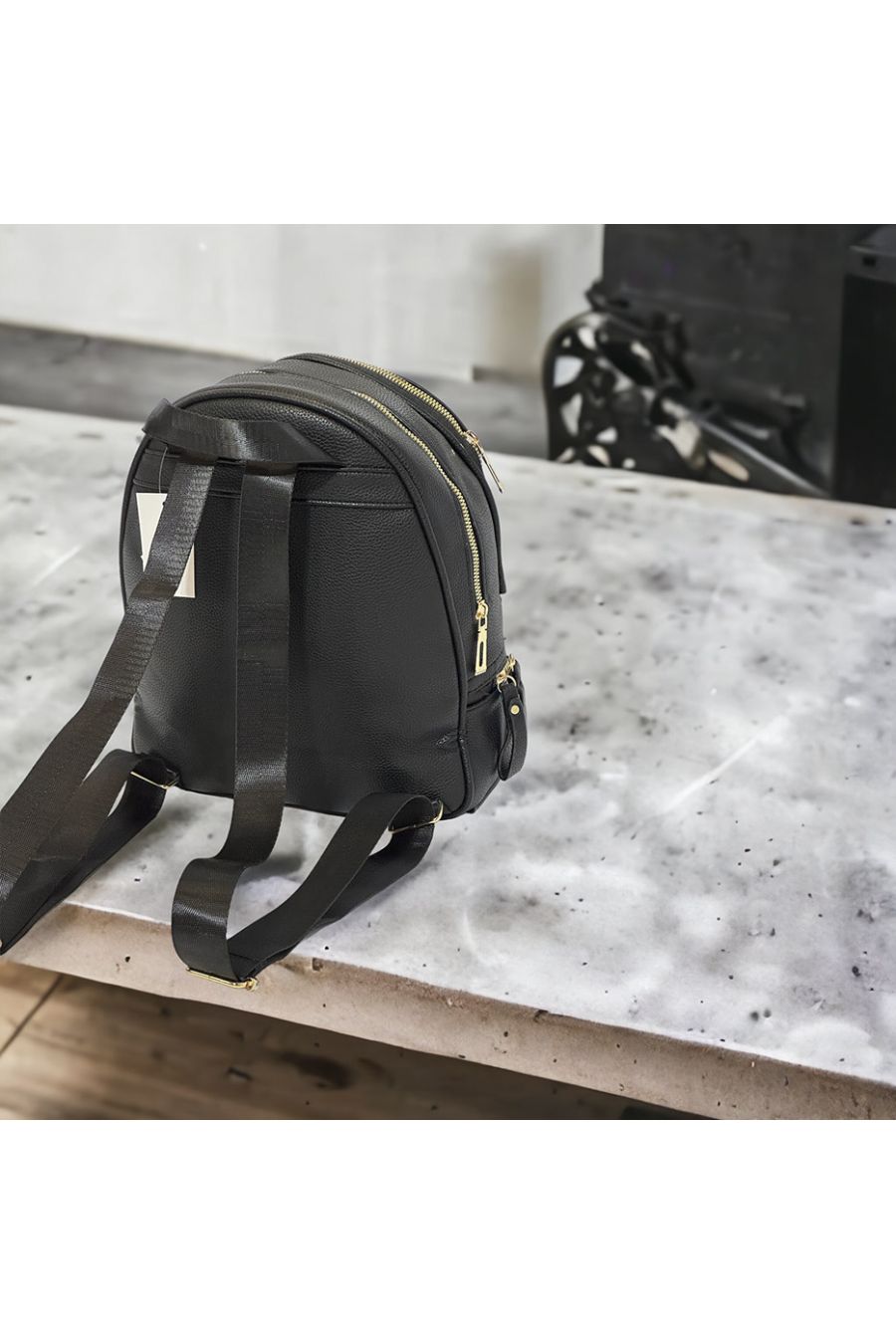 Plain black backpack with several gold closures - 1