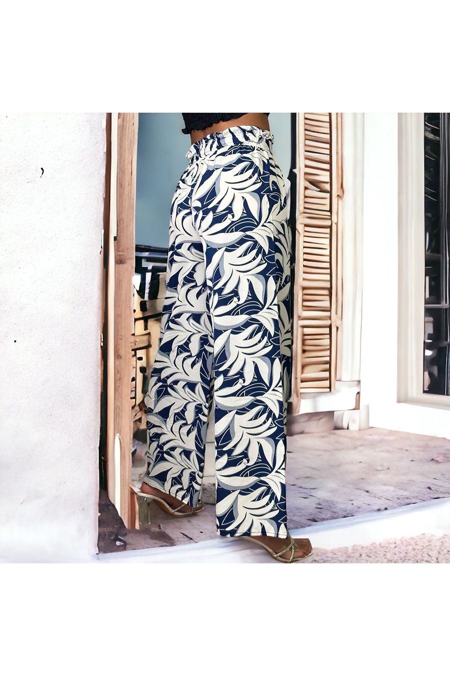 Navy bell bottom pants with floral print and foliage fitted at the waist