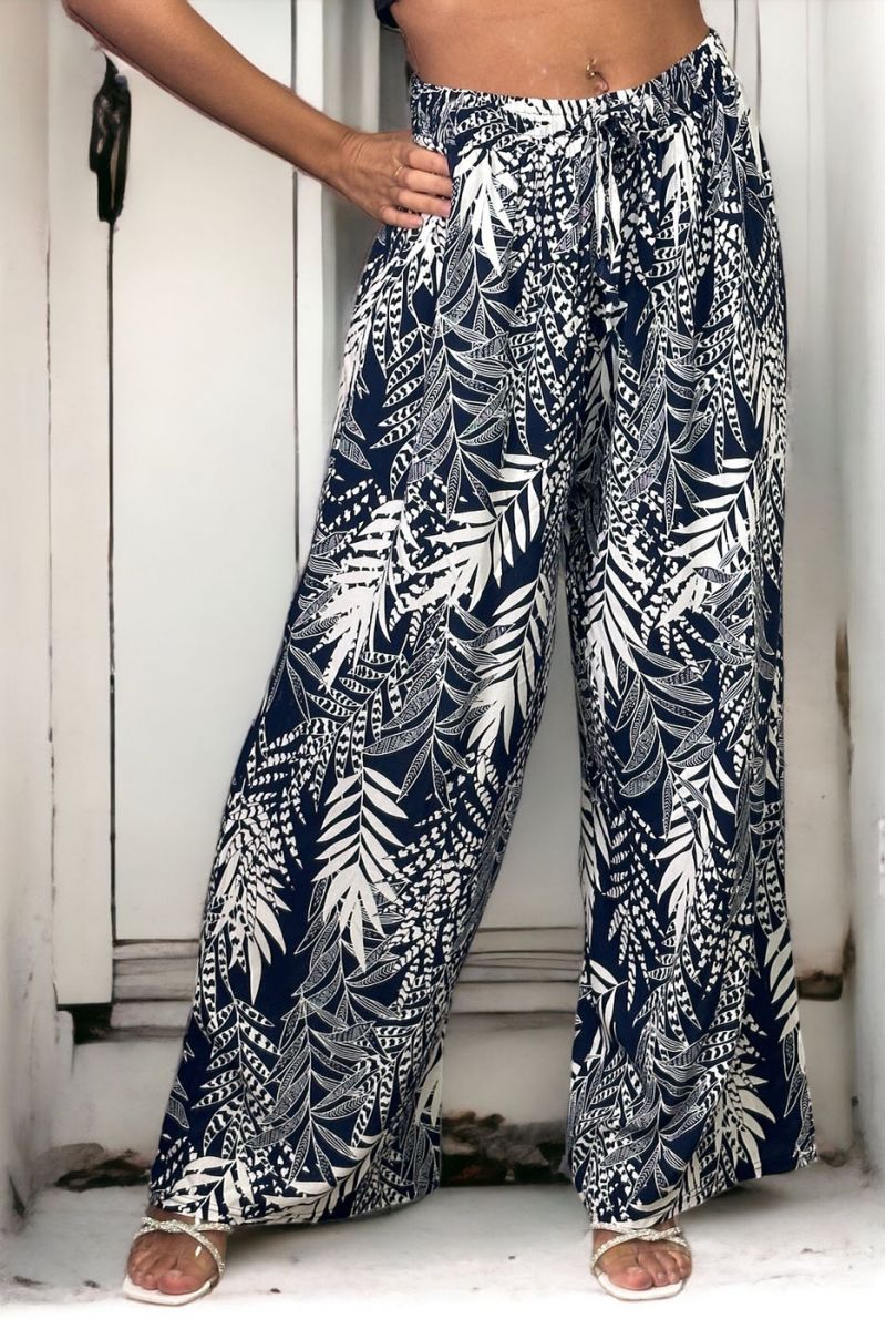 Navy bell bottom pants with floral print and foliage fitted at the waist