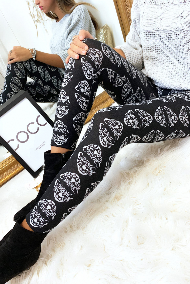 Black winter leggings with panther head patterns in white. Fashion style.