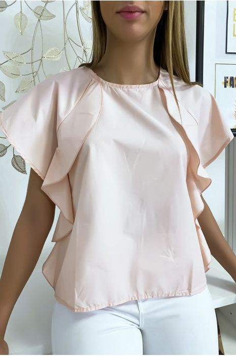 Blouse rose à volant avec trois boutons à l'épaules